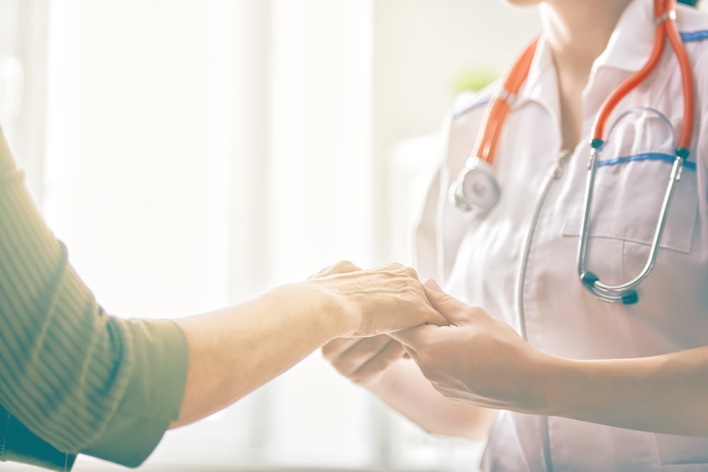 doctor holding patient's hand