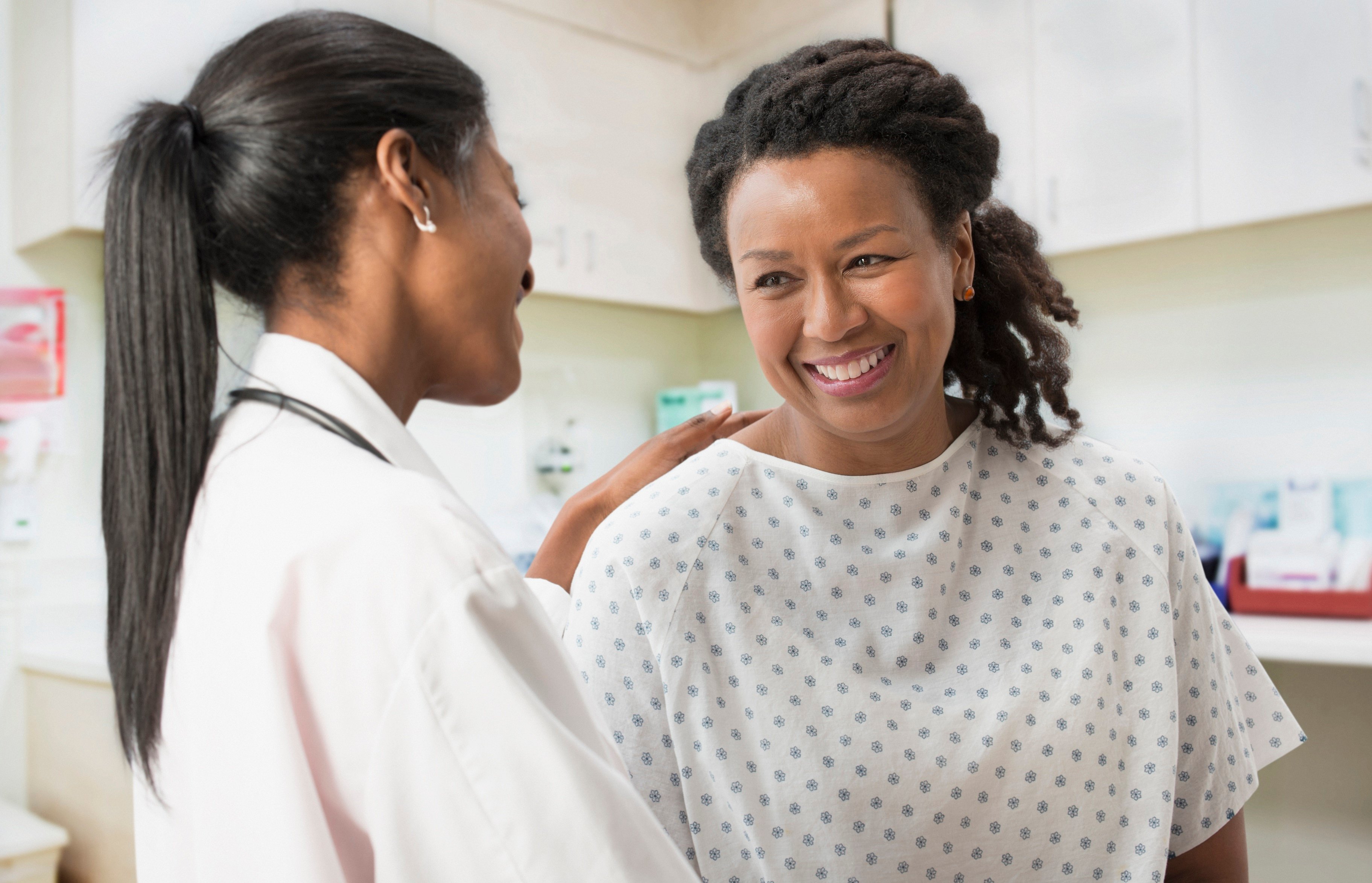 Doctor comforting patient in office